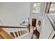Open staircase with hardwood steps and a modern light fixture, leading to the upper level at 2937 W Yarrow Cir, Superior, CO 80027