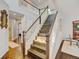 Spacious staircase with hardwood steps, connecting to an upper level, creating an airy atmosphere at 2937 W Yarrow Cir, Superior, CO 80027