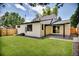 Charming backyard featuring a well-maintained lawn, patio, and a modern brick home exterior at 1980 S Kearney Way, Denver, CO 80224