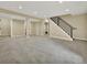 Spacious finished basement with neutral carpet, recessed lighting, and stairway with black metal railing at 1980 S Kearney Way, Denver, CO 80224