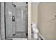 Modern bathroom featuring glass shower, hexagon tile, and white fixtures at 1980 S Kearney Way, Denver, CO 80224