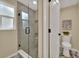 Bathroom with a frameless glass shower, tile surround, and neutral decor at 1980 S Kearney Way, Denver, CO 80224