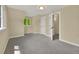 A modern bedroom with a neutral color palette, window, and open doorway at 1980 S Kearney Way, Denver, CO 80224