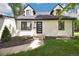 Detailed shot of the front of the home with a modern glass front door and manicured landscape at 1980 S Kearney Way, Denver, CO 80224