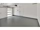 Spacious garage featuring an automatic door opener, white walls and painted concrete floors at 1980 S Kearney Way, Denver, CO 80224