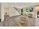 Bright living room featuring a staircase, large window, and stylish decor at 1980 S Kearney Way, Denver, CO 80224