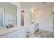 Bathroom featuring dual sinks with white countertops and modern tile floors at 3127 S Russell St, Morrison, CO 80465