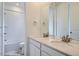 Stylish bathroom with dual sinks, modern fixtures, and a separate room for the toilet and tub at 3127 S Russell St, Morrison, CO 80465