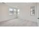 Bright and airy bedroom featuring plush gray carpeting and three sun-drenched windows at 3127 S Russell St, Morrison, CO 80465