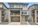 Beautiful three-story home featuring stone accents, a two-car garage, and an inviting covered porch at 3127 S Russell St, Morrison, CO 80465
