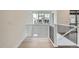 Bright hallway boasting hardwood floors, modern railings, and large windows with neighborhood views at 3127 S Russell St, Morrison, CO 80465