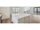 Open kitchen with a center island, white cabinetry, and hardwood floors perfect for entertaining at 3127 S Russell St, Morrison, CO 80465