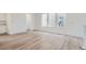 Spacious living room featuring hardwood floors, crisp white trim, and sun-drenched windows at 3127 S Russell St, Morrison, CO 80465