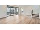 Open living room showcasing hardwood floors, deck access, and stairs to the upper level at 3127 S Russell St, Morrison, CO 80465