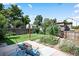 Inviting backyard with a green lawn, patio area, and lush greenery for outdoor enjoyment at 1295 Elm St, Denver, CO 80220