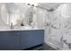 Modern bathroom with double vanity, marble shower, and stylish fixtures at 1295 Elm St, Denver, CO 80220