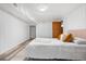 Cozy bedroom with wood-look flooring, white walls and trim, and comfortable queen-sized bed at 1295 Elm St, Denver, CO 80220