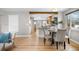Open-concept dining area with hardwood floors, modern chairs, and seamless flow to the bright kitchen at 1295 Elm St, Denver, CO 80220