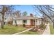 Lovely home featuring red brick, a well-kept lawn and landscaping, and a welcoming entrance at 1295 Elm St, Denver, CO 80220