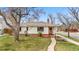 Beautiful house with lush green grass, mature tree, and lovely front entryway at 1295 Elm St, Denver, CO 80220