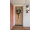 Beautiful front door with decorative wreath, brick accents, and sleek modern lighting at 1295 Elm St, Denver, CO 80220