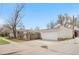 Detached garage with a white door and long driveway at 1295 Elm St, Denver, CO 80220