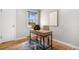 Bright home office features modern desk, wood floors, neutral decor, and natural light from a window at 1295 Elm St, Denver, CO 80220
