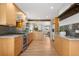 Modern kitchen with stainless steel appliances, wood cabinets, and an open layout at 1295 Elm St, Denver, CO 80220