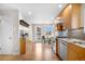 Well-lit kitchen featuring wood cabinets, stainless steel appliances, and exterior access at 1295 Elm St, Denver, CO 80220