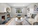 Bright living room with fireplace, large window, and modern decor featuring a gray sofa at 1295 Elm St, Denver, CO 80220