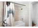 Bathroom featuring shower/tub combo with white tiled walls and modern shower curtain at 391 N 7Th Ave, Brighton, CO 80601