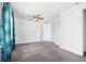 Bright bedroom featuring gray carpet, a ceiling fan, and ample natural light at 391 N 7Th Ave, Brighton, CO 80601