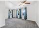 Spacious bedroom featuring plush carpet, three bright windows, and neutral walls at 391 N 7Th Ave, Brighton, CO 80601