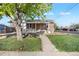 Charming single-story home with a well-maintained lawn and inviting front porch at 391 N 7Th Ave, Brighton, CO 80601