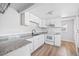 Well-lit kitchen featuring white cabinets, stainless steel appliances, and sleek countertops at 391 N 7Th Ave, Brighton, CO 80601