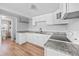 Cozy kitchen featuring white cabinets, stainless steel appliances, and granite countertops at 391 N 7Th Ave, Brighton, CO 80601