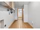 Laundry room featuring wood floors and hookups at 391 N 7Th Ave, Brighton, CO 80601