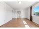 Living room with neutral walls, wood-look tile flooring, and a view to the staircase at 391 N 7Th Ave, Brighton, CO 80601