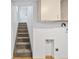 Carpeted stairs leading up to a door and a small cabinet at 391 N 7Th Ave, Brighton, CO 80601