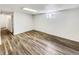 Finished basement with wood flooring, a window, and ample space for recreation or storage at 3118 S Joplin Ct, Aurora, CO 80013