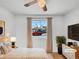 Bright, virtually staged bedroom with a ceiling fan, and a large window at 3118 S Joplin Ct, Aurora, CO 80013