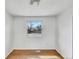 Cozy bedroom with wood floors, a window offering natural light, and neutral walls at 3118 S Joplin Ct, Aurora, CO 80013