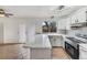 Bright kitchen with white cabinetry, modern appliances, and an island countertop at 3118 S Joplin Ct, Aurora, CO 80013