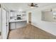 Kitchen featuring white cabinets, modern appliances, tile floors, and an open design that connects to the dining area at 3118 S Joplin Ct, Aurora, CO 80013