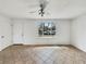 Bright living room featuring neutral tones, a ceiling fan, and a large window at 3118 S Joplin Ct, Aurora, CO 80013