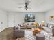 Bright, virtually staged living room featuring neutral tones, a ceiling fan, and a large window at 3118 S Joplin Ct, Aurora, CO 80013