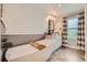 Bright bathroom featuring a soaking tub, marble floors, and a vanity with vessel sink and modern fixtures at 2023 S Rifle St, Aurora, CO 80013