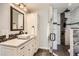 Bright bathroom with granite counters, modern cabinets, a glass shower and designer tile at 2023 S Rifle St, Aurora, CO 80013