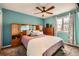 Comfortable bedroom with a ceiling fan, a window with curtains, and matching furniture at 2023 S Rifle St, Aurora, CO 80013
