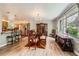 Bright dining room with wood floors and a view to the kitchen, creating an open and inviting space at 2023 S Rifle St, Aurora, CO 80013